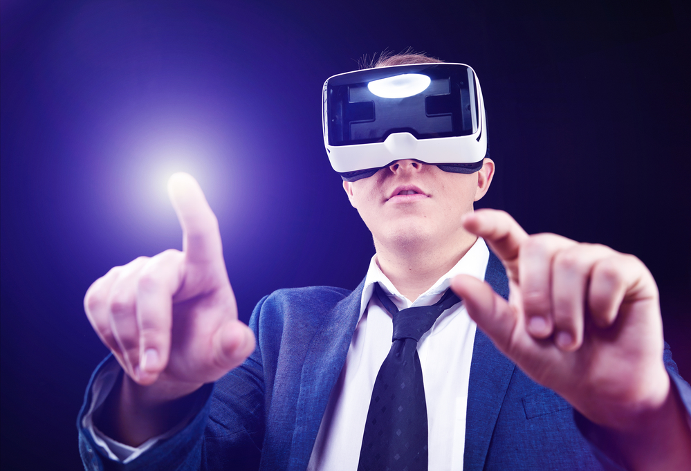 Man uses Virtual Realitiy VR head-mounted display with fun Businessman has fun using his Virtual Realitiy VR glasses - fundraising events