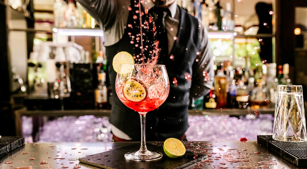Barman is making cocktail at night club. Barman is making cocktail - what is corporate hospitality