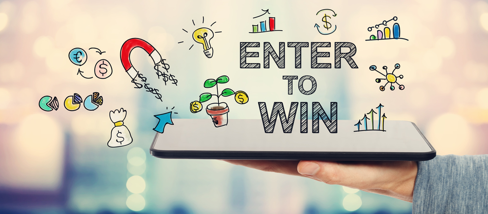 Enter To Win concept with man holding a tablet Enter To Win concept with man holding a tablet computer - social media competition ideas