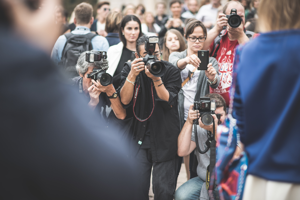 MILAN, ITALY - SEPTEMBER 20: People during Milan Fashion week in Milan, Italy on September, 20 2014.professional photographers in the outside city during the Milan fashion week shooting eccentric people